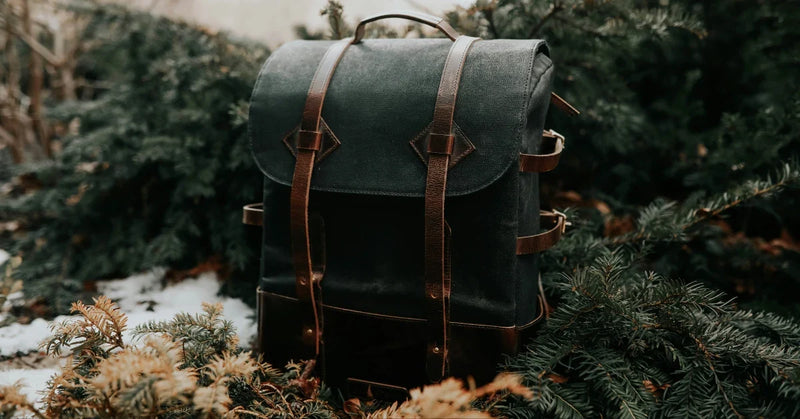 Heritage waxed-canvas rucksack with leather straps and a buckled top flap